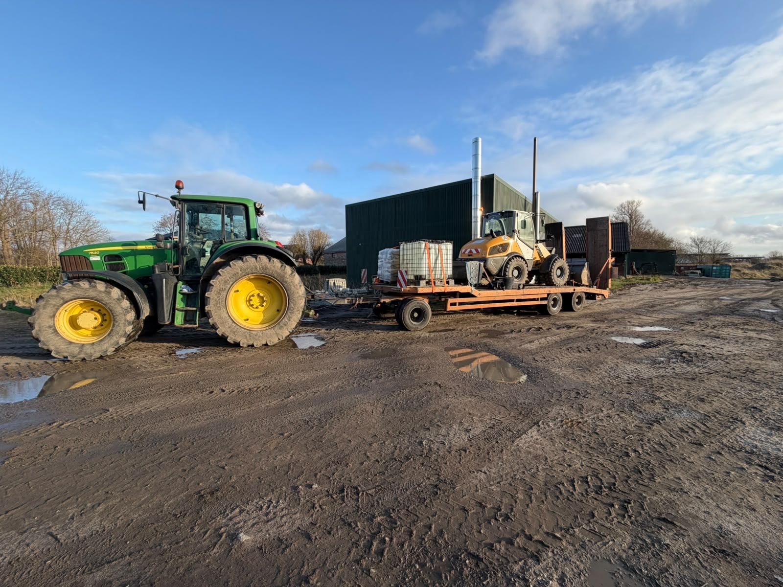 Traktor mit Tieflader und Gerät
